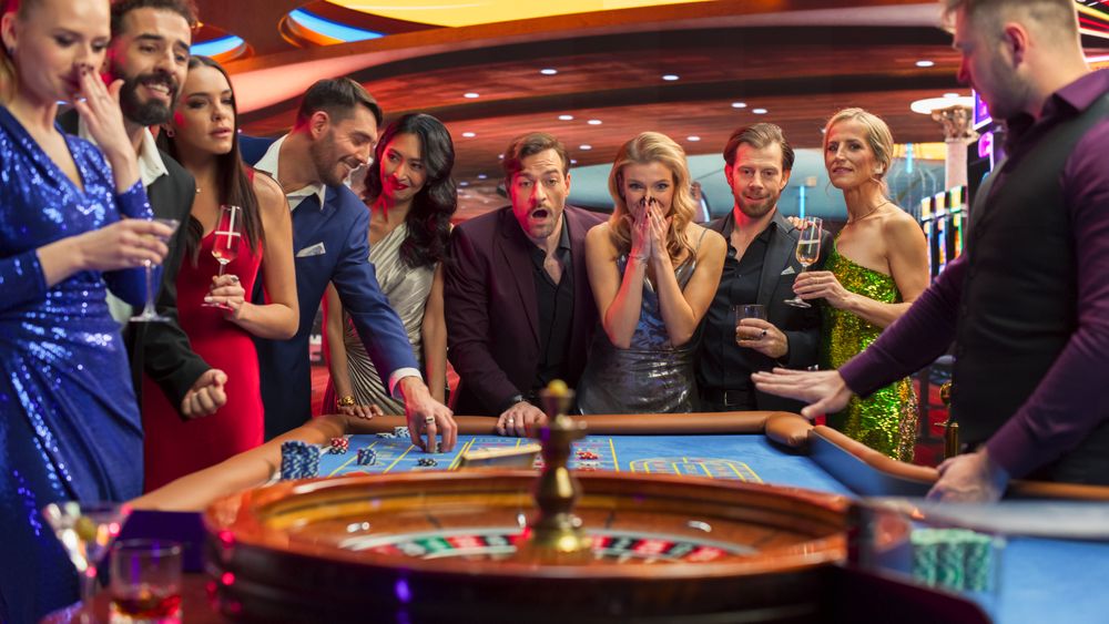 Casino Players Making Bets at a Roulette Table. Vibrant Crowd of International Young People Enjoying Nightlife in a City.