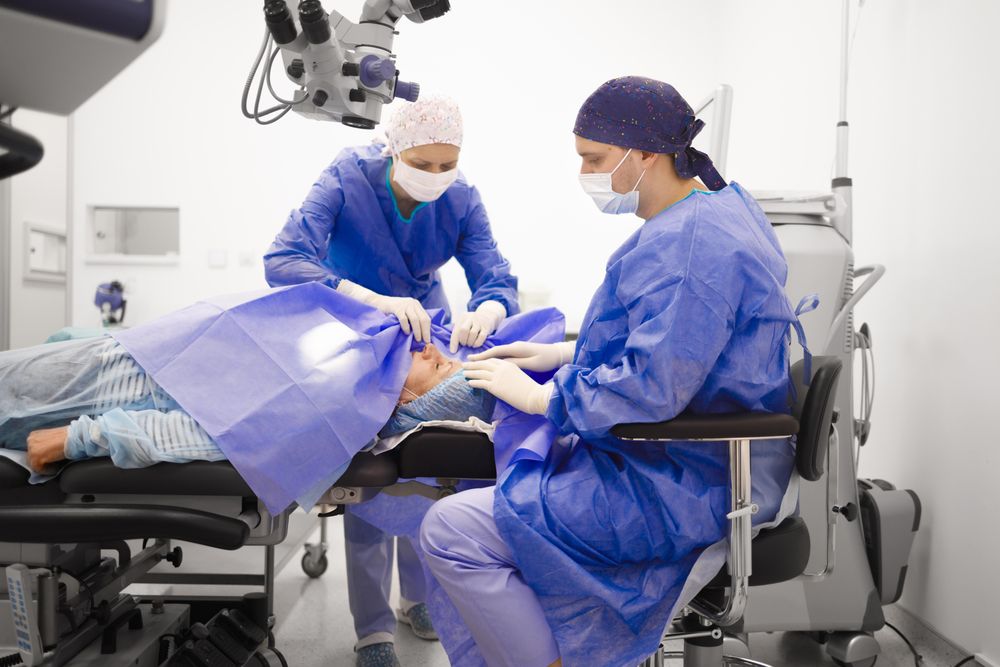 Older female patient being prepped for cataract surgery by nurses