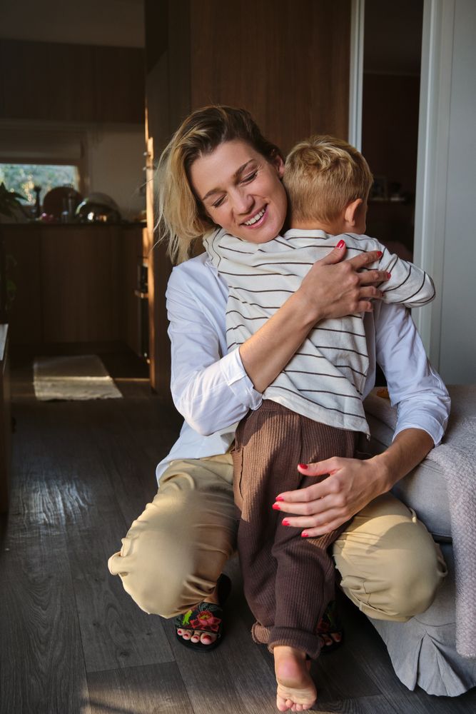 Mother embracing son in cozy room