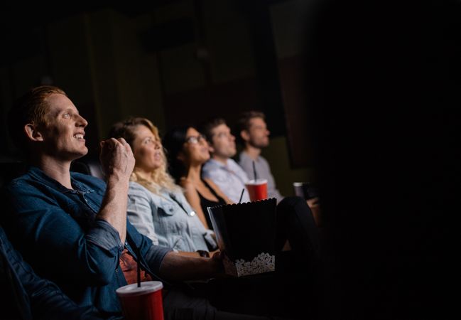 Group of people in movie theater enjoying a film