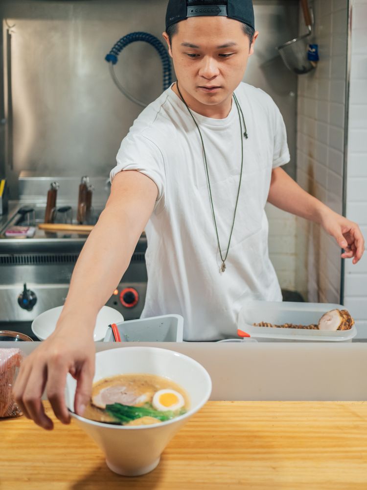 Asian chef with served bowls of ramen
