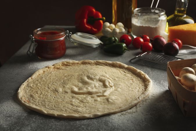 Concept for cooking pizza with ingredients on gray table