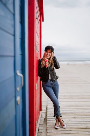 Woman eating an apple near bright wooden cabins