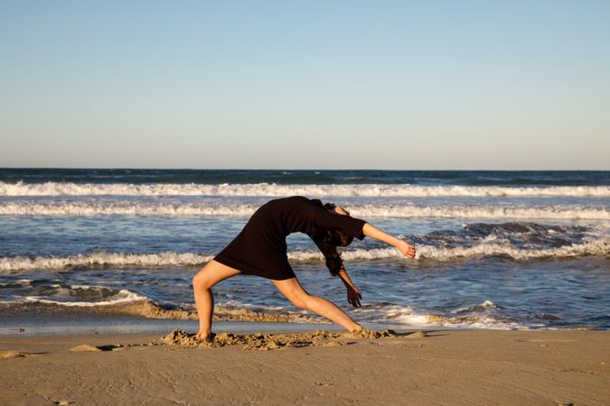 Woman with dancing near water on shore