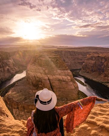 Woman sitting beside the horseshoe bend  in Glen Canyon National Recreation Area in Arizona,USA