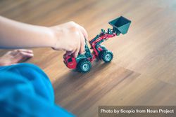 Cropped image of child playing with dump truck toy 42xkm0