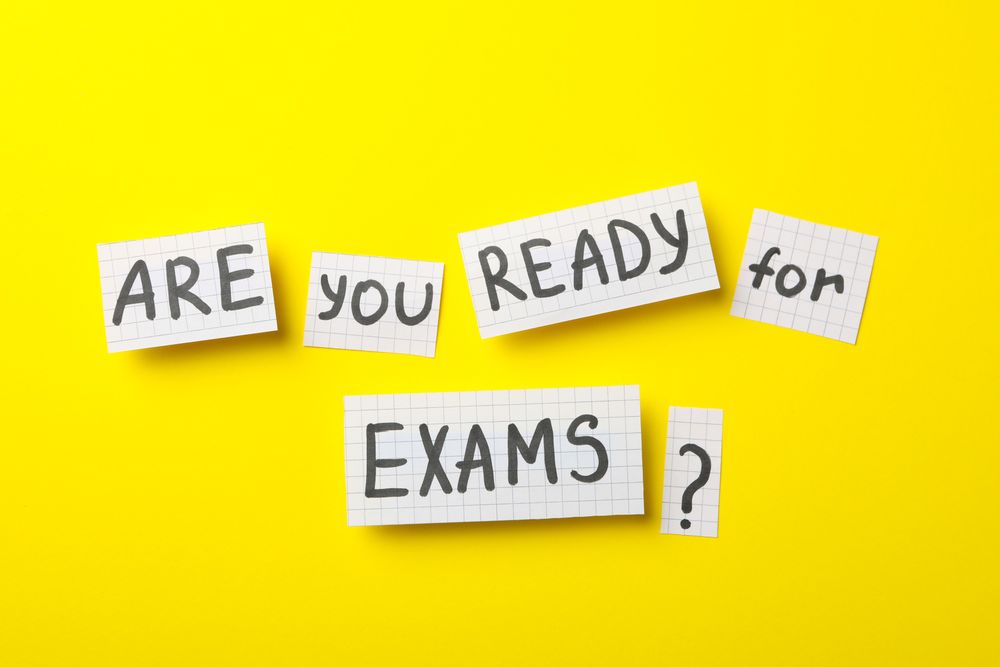Flat lay of “are you ready for exams” on yellow table