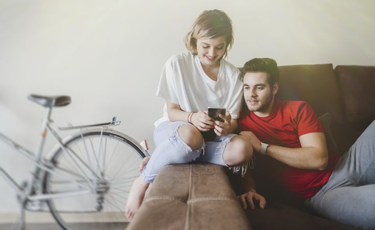 Couple on sofa on the mobile phone