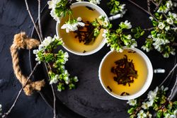 Tea time concept of loose leaf tea in cups with buds