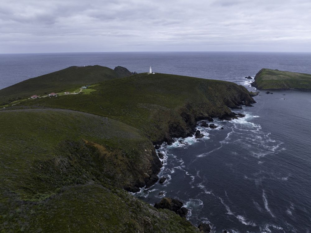 Lighthouse in distance by coast