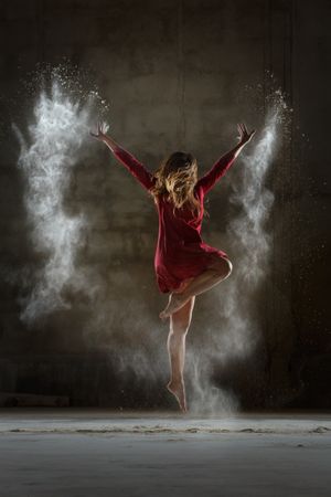 Young woman between fog in darkness