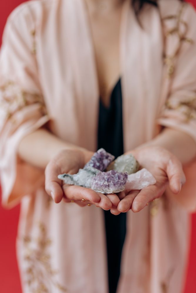 Cropped image of woman holding colorful stones