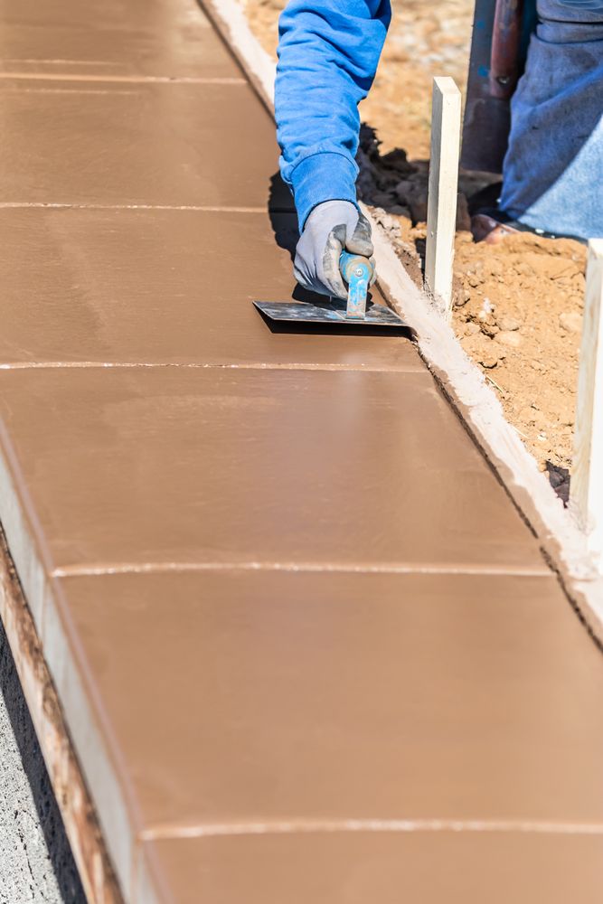 Construction Worker Using Stainless Steel Edger On Wet Cement Forming Coping Around New Pool
