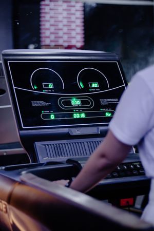 Exercising with Tech: Person on Treadmill Tracking Fitness Data