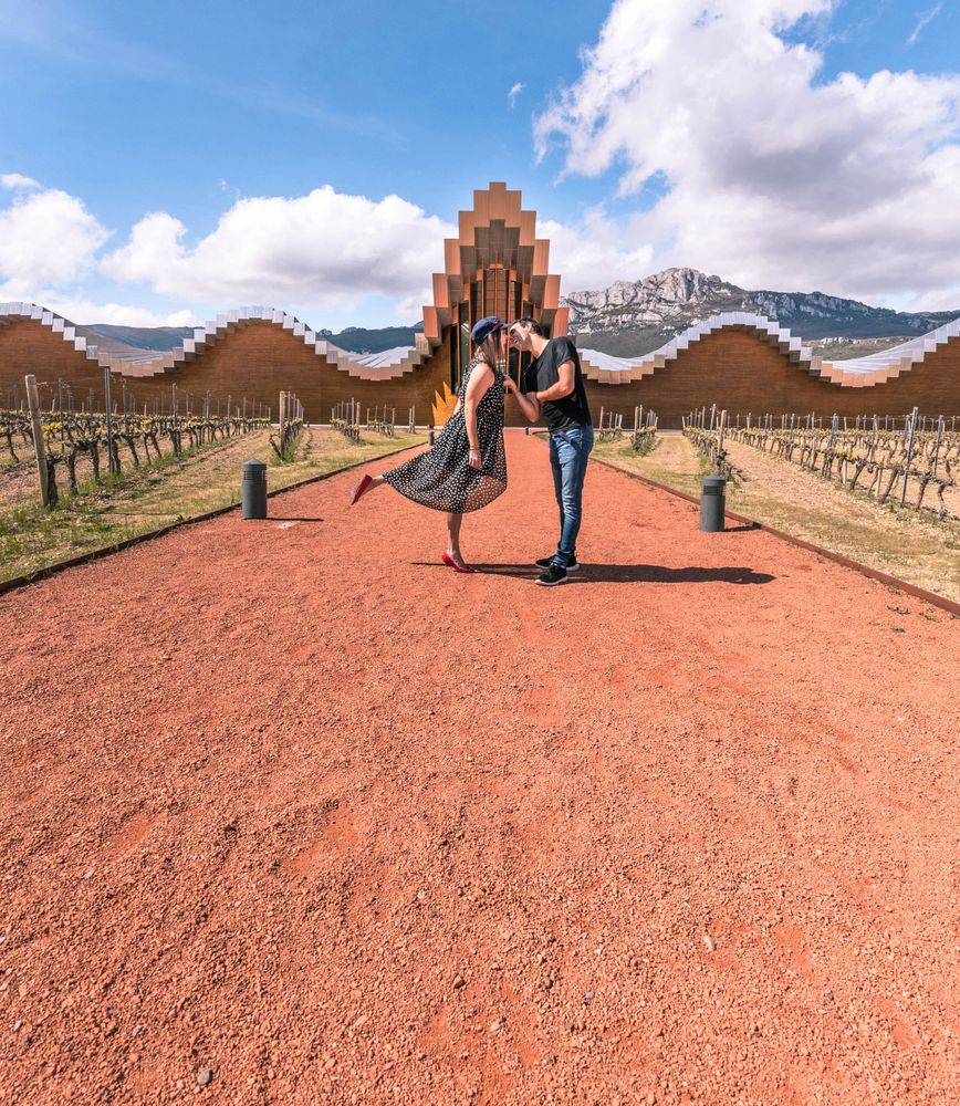 Couple walking along breathtaking geometric architectural building
