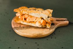 Flat bread sandwich on wooden cutting board