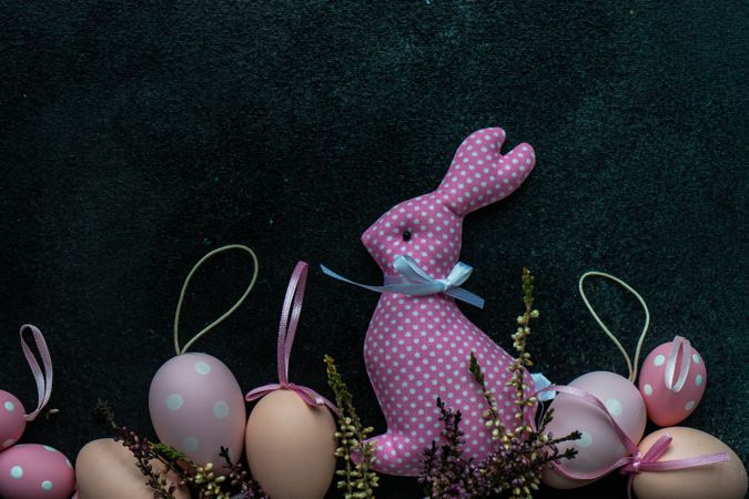 Easter holiday card concept with pink rabbit ornament and egg decor