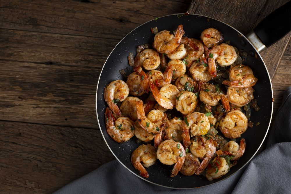 Delicious grilled prawns on wooden background.