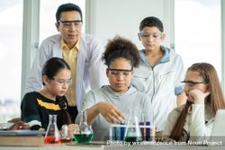 Girl working with beakers in chemistry class 0KXv15