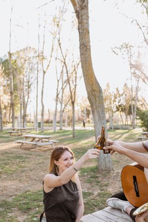 Young musicians drinking beer in park
