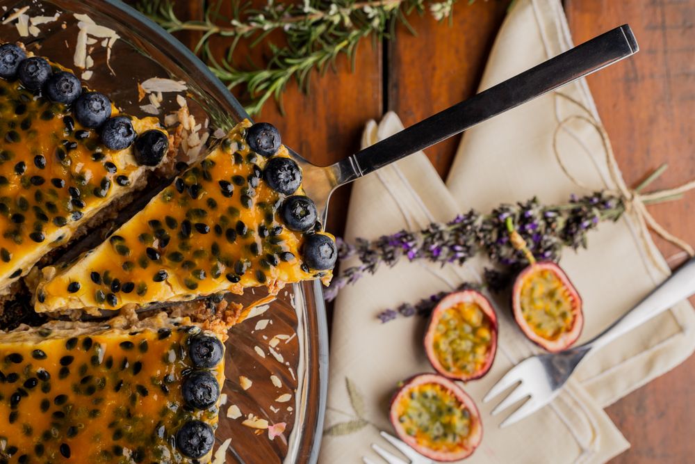 Tasty piece of passion fruit pie decorated with blueberry
