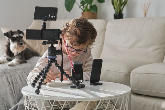 Creative boy recording video for blog at home