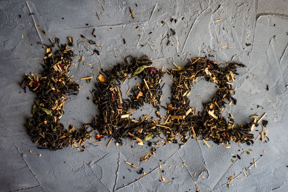 Floral tea on counter spelling "tea"