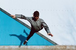 Trendy male flipping on street