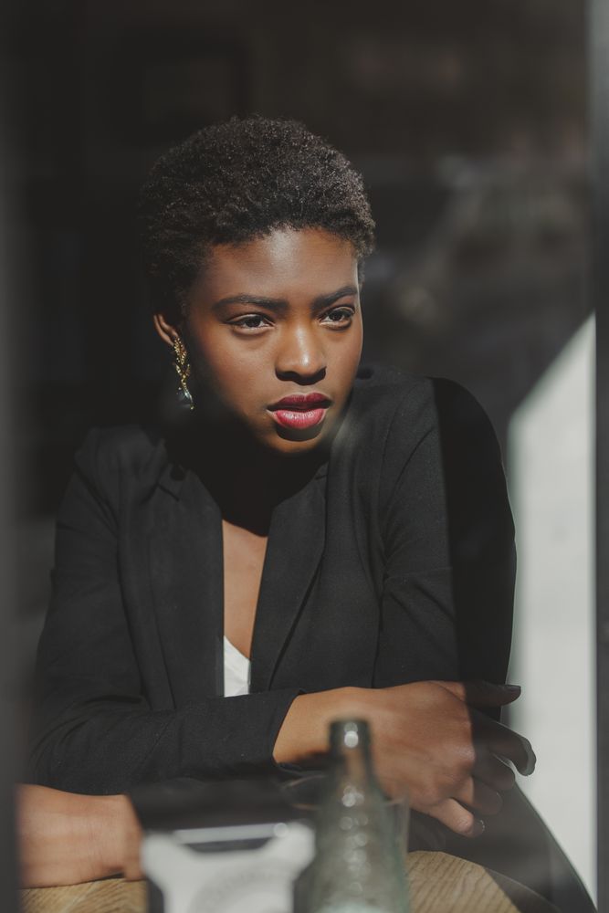 Smiling stylish Black woman in cafe
