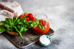 Fresh tomato juice on kitchen counter with garnish