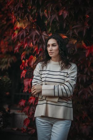 Fashion woman on a background of red and yellow autumn leaves
