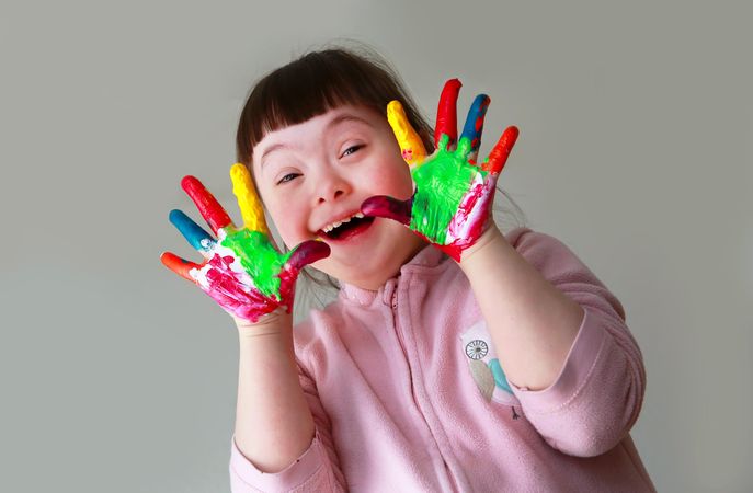 Excited little girl showing her hands to the camera