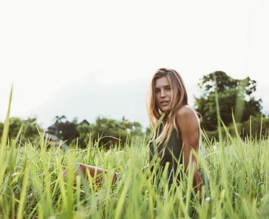 Female model in the meadow looking at camera