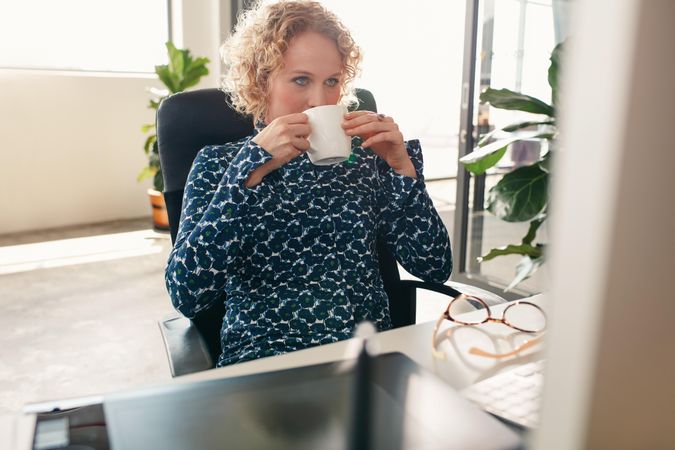 Thoughtful designer having coffee at home office