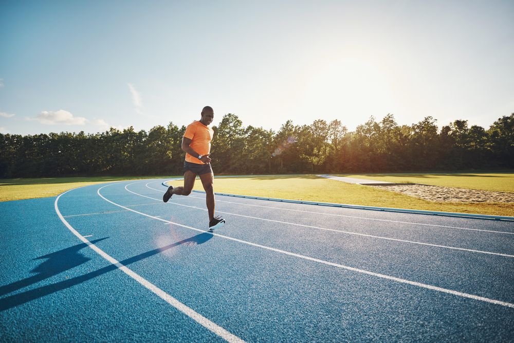 Man jogging on athletic track