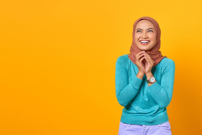 Muslim woman happy with hands together below her chin