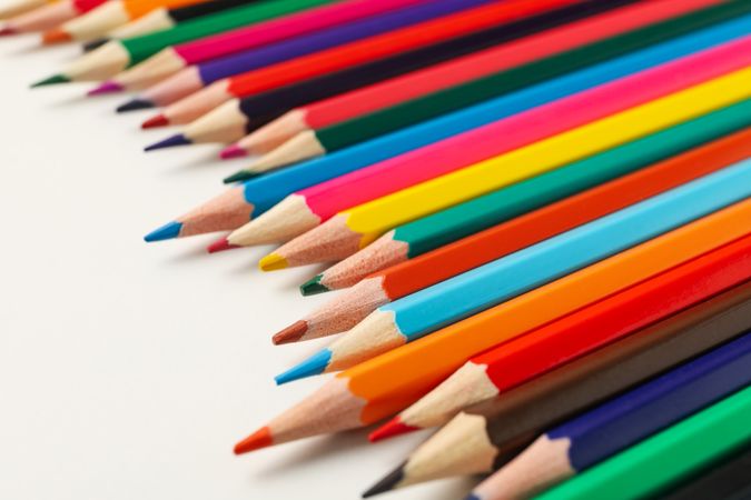 Colorful pencils on blank background, close up
