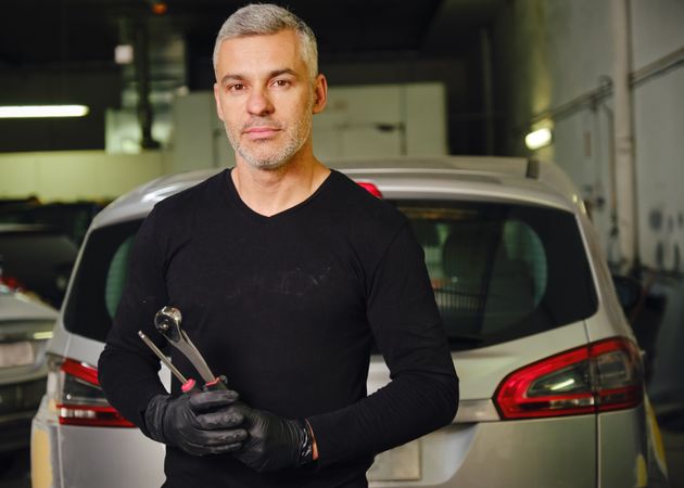 Confident mechanic in garage