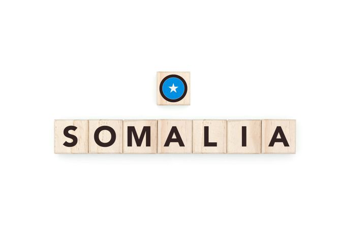 Wooden blocks bearing the name and flag of Somalia. Somali and African Culture, national identity, travel, and geography in a copy space design.
