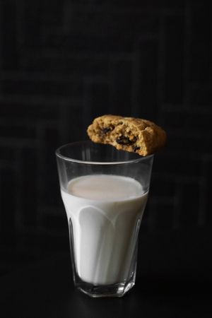 A glass of milk and raisin cookies