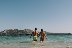 Happy couple walking on sea