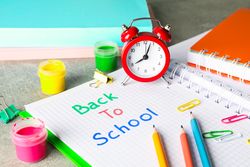 Composition with school supplies on grey background, space for text