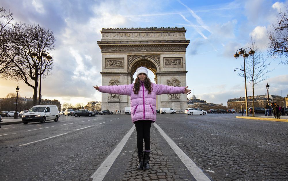 Girl standing against triumphal arch