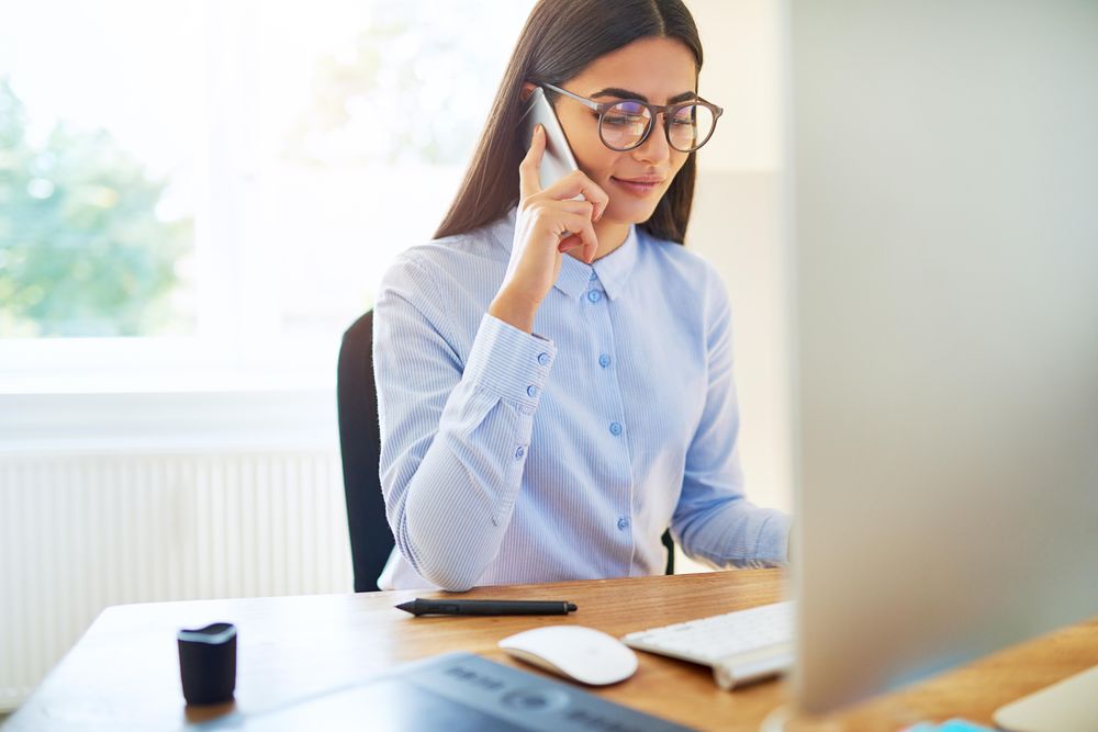 Female entrepreneur working from home taking a phone call