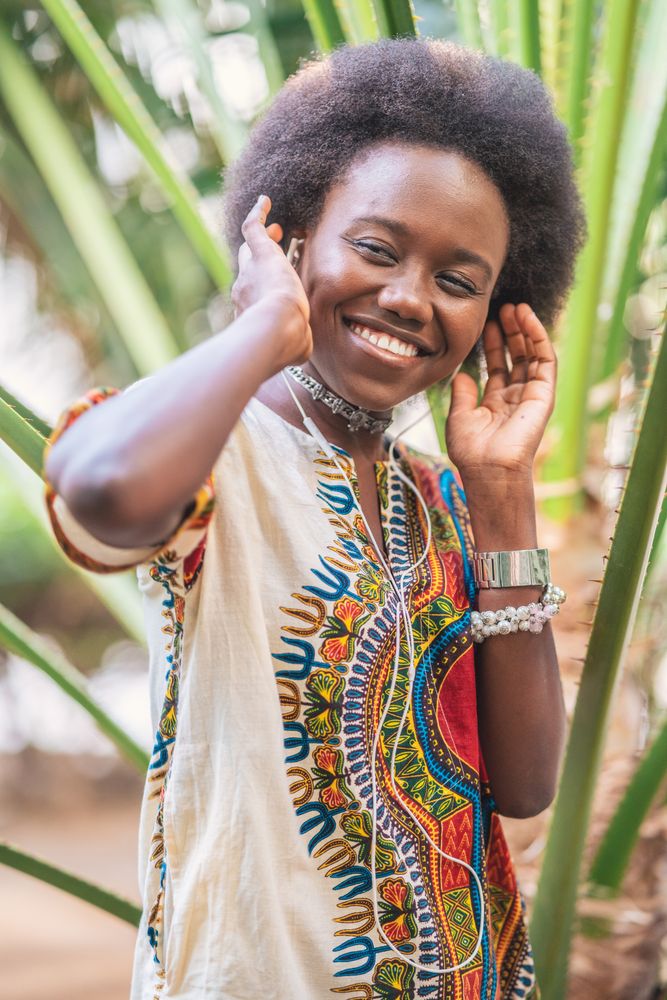 Smiling Black woman listening to music