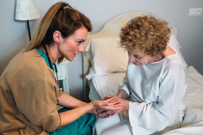 Doctor giving encouragement to mature patient