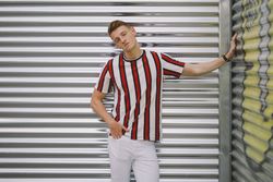 Man leaning on steel garage door
