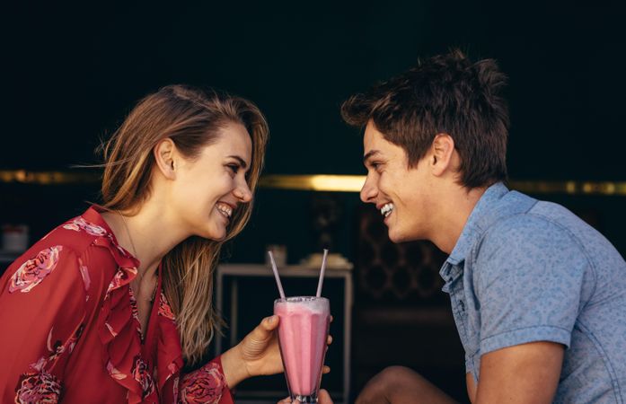 Loving couple looking at each other sitting at a restaurant