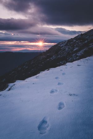 Sun setting over snowy mountains