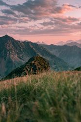 Stony valley surrounded by mountain under cloudy sky